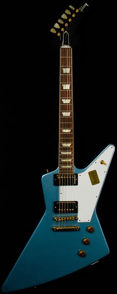 a blue and white guitar sitting on top of a black background with five strings attached to it