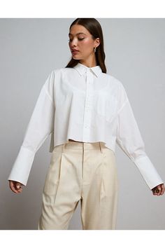 Organic cotton poplin/Extra long cuffs for an exaggerated uncuffed look/MOP button closure/Raw hem Cotton Cropped Shirt With Button Cuffs For Spring, Classic Spring Cropped Shirt With Button Cuffs, Spring Long Sleeve Cropped Shirt With Button Cuffs, Modern Cropped Shirt For Spring Workwear, Classic Cropped Shirt For Office In Spring, Classic Spring Cropped Shirt For Office, Modern Long Sleeve Cropped Shirt For Work, Trendy Long Sleeve Cropped Shirt For Daywear, Modern Cropped Long Sleeve Shirt