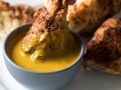 chicken wings dipped with mustard in a bowl