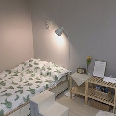 a small bedroom with a bed, desk and chair in the corner next to it