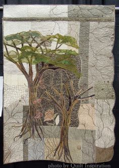 a patchwork quilt with an elephant and trees on it