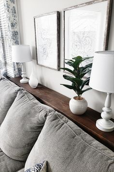 a living room with two framed pictures on the wall