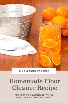 homemade floor cleaner recipe with oranges in mason jar and metal bucket on wooden table