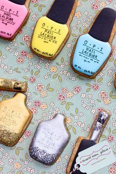 decorated cookies with nail polish on them sitting on a table