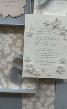 the wedding stationery is laid out on top of each other