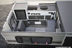 an overhead view of the inside of a camper with its door open and windows opened