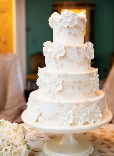 a white wedding cake sitting on top of a table