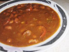 a white plate topped with beans and meat