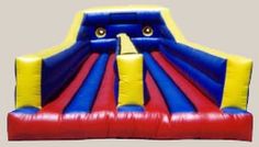 an inflatable bouncer with two yellow and blue tubes on it's side