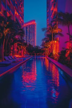 A large hotel pool designed for both swimming and lounging, surrounded by deck chairs and lush palm trees.