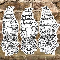 some stickers that are on the side of a brick wall with flowers and ships