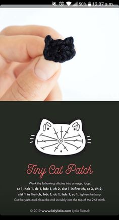 a hand holding a tiny black and white cat brooch with the words tiny cat patch on it