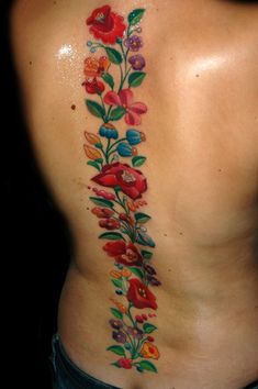 a woman's back with flowers on it