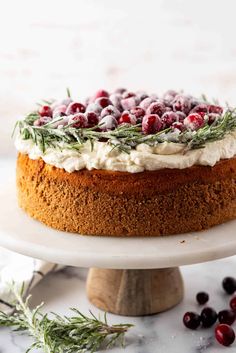 a cake with cranberries and rosemary on top