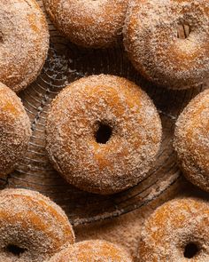 several sugared donuts are on a wire rack