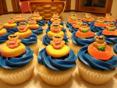 cupcakes with teddy bears on them in blue icing and yellow frosting