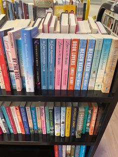 a book shelf filled with lots of books on top of each other in a library