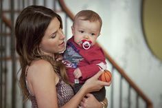 a woman holding a baby in her arms