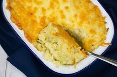 a casserole dish with broccoli and cheese in it on a white plate