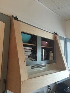 an open cabinet in the corner of a room