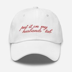 Grab your bride to be our new favorite hat featuring the phrase, "Put it on my husbands tab." Perfect for bachelorette parties or days at the lake or beach! * Unstructured, 6-panel, low-profile * 6 embroidered eyelets * Adjustable strap with antique buckle White Wedding Hat (one Size Fits Most), White Wedding Hats One Size Fits Most, White Wedding Hat, One Size Fits Most, White Wedding Hats, One Size Fits Most, White Curved Brim Baseball Cap For Wedding, Adjustable White Hat For Anniversary, Wedding Hat With Flat Brim, One Size Flat Brim Hat For Weddings, Adjustable Size Flat Brim Hat For Weddings