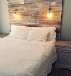 a bed with two lights on the headboard