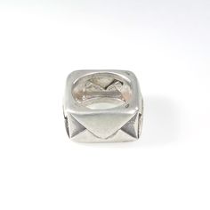 a silver ring with an envelope on the front, and a diamond in the middle