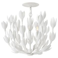 a white chandelier hanging from a ceiling fixture with flowers and leaves on it