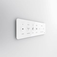 a white control panel mounted to the side of a wall