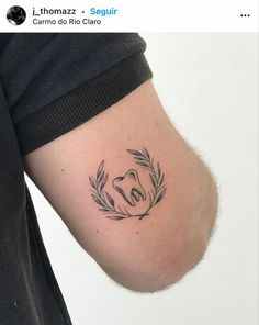 a person with a tattoo on their arm that has a koala head in it