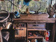 the inside of a vehicle with various items on it and an open shelf in the back