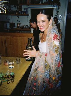 a woman wearing a veil holding a vase