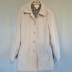 Merona Jacket Cream Colored Shoulder Padding Front Pockets Button Up Pleaded Back Thick Water Repelling Material 100% Polyester Armpit Width Laid Flat 21.5" Length From Armpit Down 21.5" Sz. M Nwot Spring Cream Outerwear With Covered Buttons, Casual Fitted Outerwear With Covered Buttons, Classic Spring Outerwear With Covered Buttons, White Button-up Outerwear With Covered Buttons, Spring Casual Blazer With Covered Buttons, Casual Spring Blazer With Covered Buttons, Cream Trench Coat, Cream Color, Trench Coat