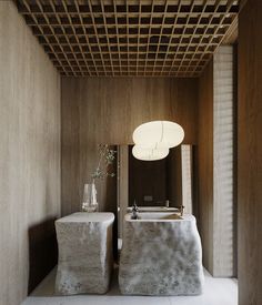 two stone sinks in a bathroom under a wooden ceiling