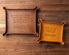 two personalized trays sitting on top of a wooden table next to each other