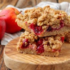 three pieces of fruit crumbled on top of a wooden cutting board