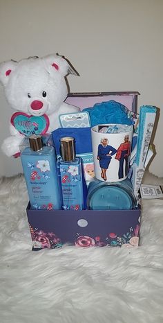 a white teddy bear sitting next to a box filled with personal care items