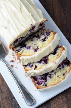 slices of blueberry pound cake on a white plate with a fork next to it