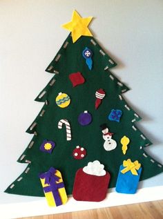 a christmas tree made out of felt on the wall