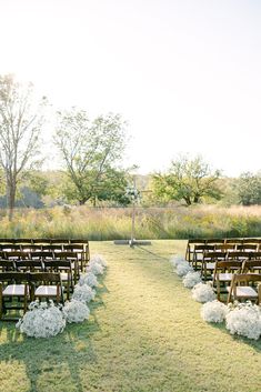 an outdoor ceremony setup with chairs and flowers