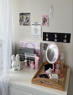 a white desk topped with a mirror and toys