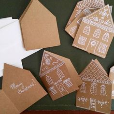 some brown paper with white designs on them and envelopes sitting next to each other