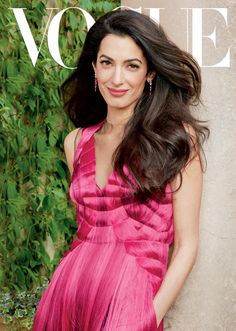 a woman in a pink dress on the cover of a magazine with greenery behind her