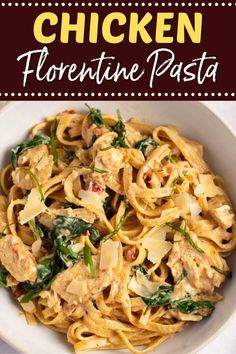 chicken fettuccine pasta with spinach and cheese in a white bowl