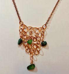 This ancient Egyptian style, chain mail effect,  bib necklace has been made with Copper wire which has been coiled to form layers of loops, which are joined together with copper jump rings and has been embellished with 3 strategically placed Malachite chips. The bib is hung from copper chain with a lobster claw clasp. Bib width: 3.5cm Bib height: 6cm Chain length: 18"(45.5cm) Egyptian Inspired, Egyptian Style, Bib Necklaces, Chain Mail, Copper Chain, Bib Necklace, Ancient Egyptian, Jump Rings, Copper Wire