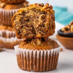 muffins stacked on top of each other with one bite taken out of it