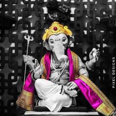 an elephant statue sitting on top of a table next to a black and white background