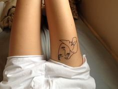 a woman's legs with a tattoo on her left leg and the outline of a dog