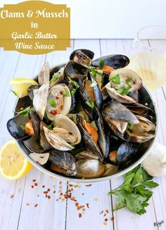 steamed clams and mussels in garlic butter wine sauce with lemon wedges