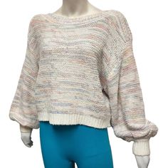 a mannequin wearing a white sweater and blue pants